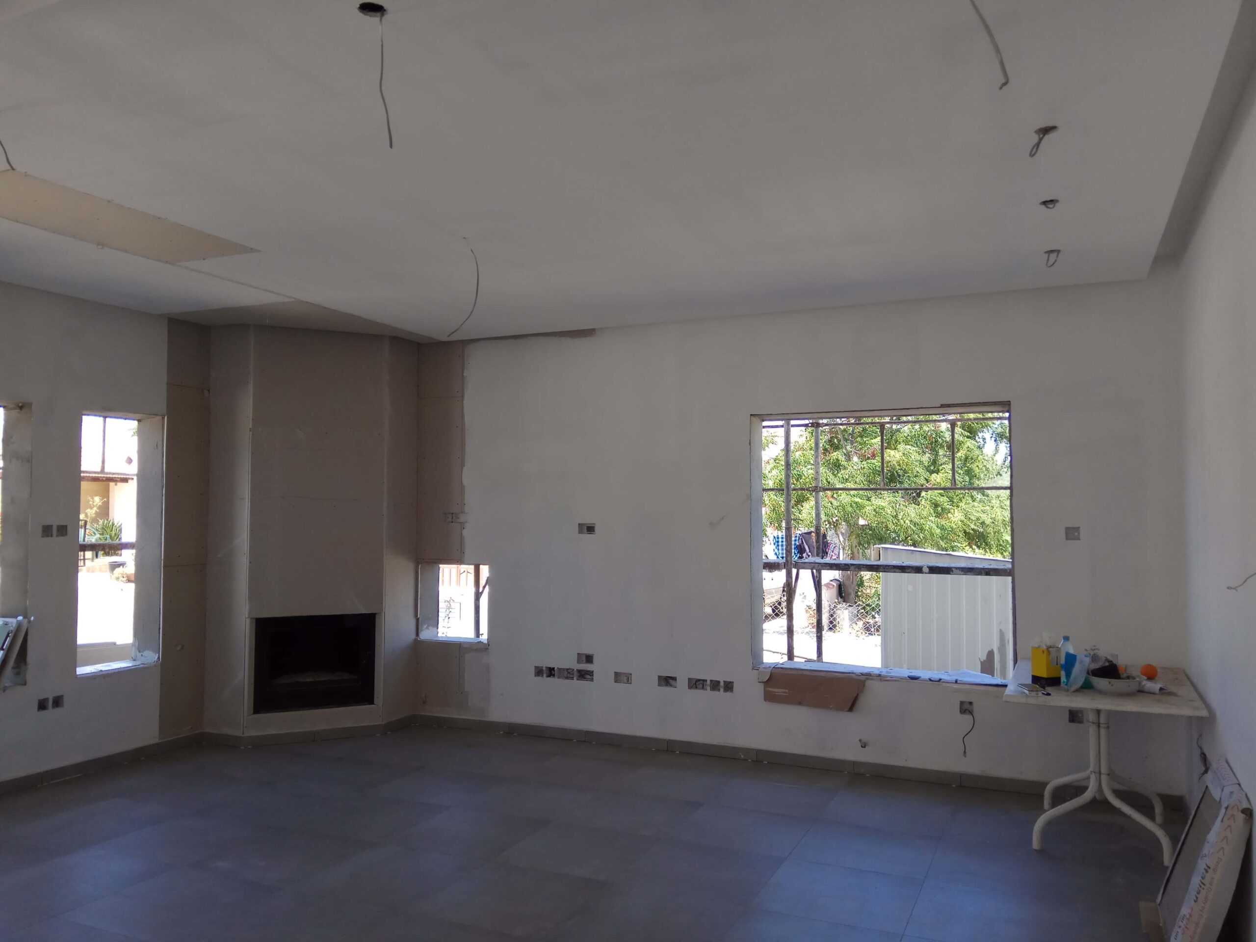 Open-plan living area with fireplace at the Xylofagou residence